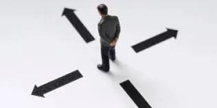 An image of a person looking at arrows on the floor