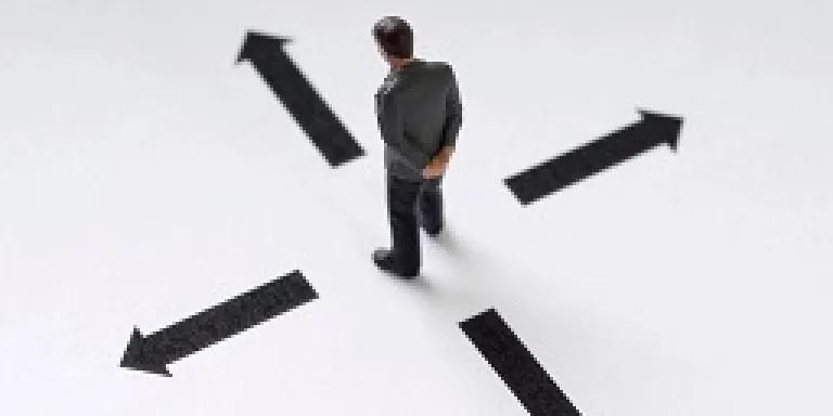 An image of a person looking at arrows on the floor