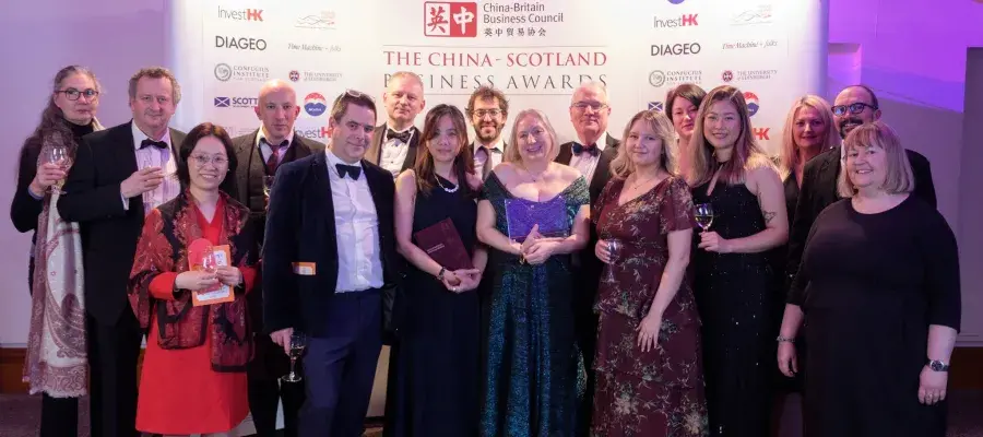 An im The ZJE team collecting their award at the CBBC forum in 2024 standing on the steps outside the ZJE University