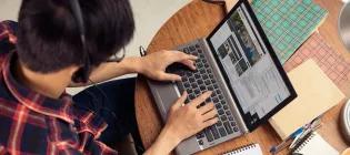 Photo of a male student studying on a laptop