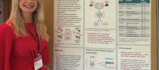 A photo of Isabelle Smith standing next to her research poster