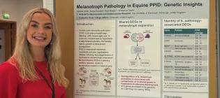 A photo of Isabelle Smith standing next to her research poster