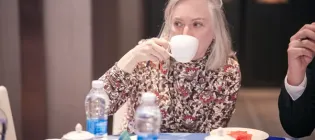 A photo of Prof Sue Welburn drinking tea 