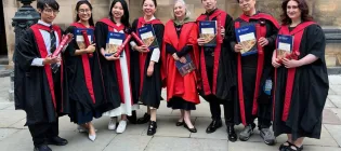 Prof Sue Welburn standing with the 2026 ZJE PG graduates outside the McEwan Hall. 