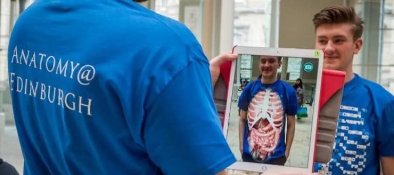 Volunteers at the Science Saturday event at the Museum demonstrating the anatomy app on the Ipad
