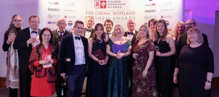 An im The ZJE team collecting their award at the CBBC forum in 2024 standing on the steps outside the ZJE University