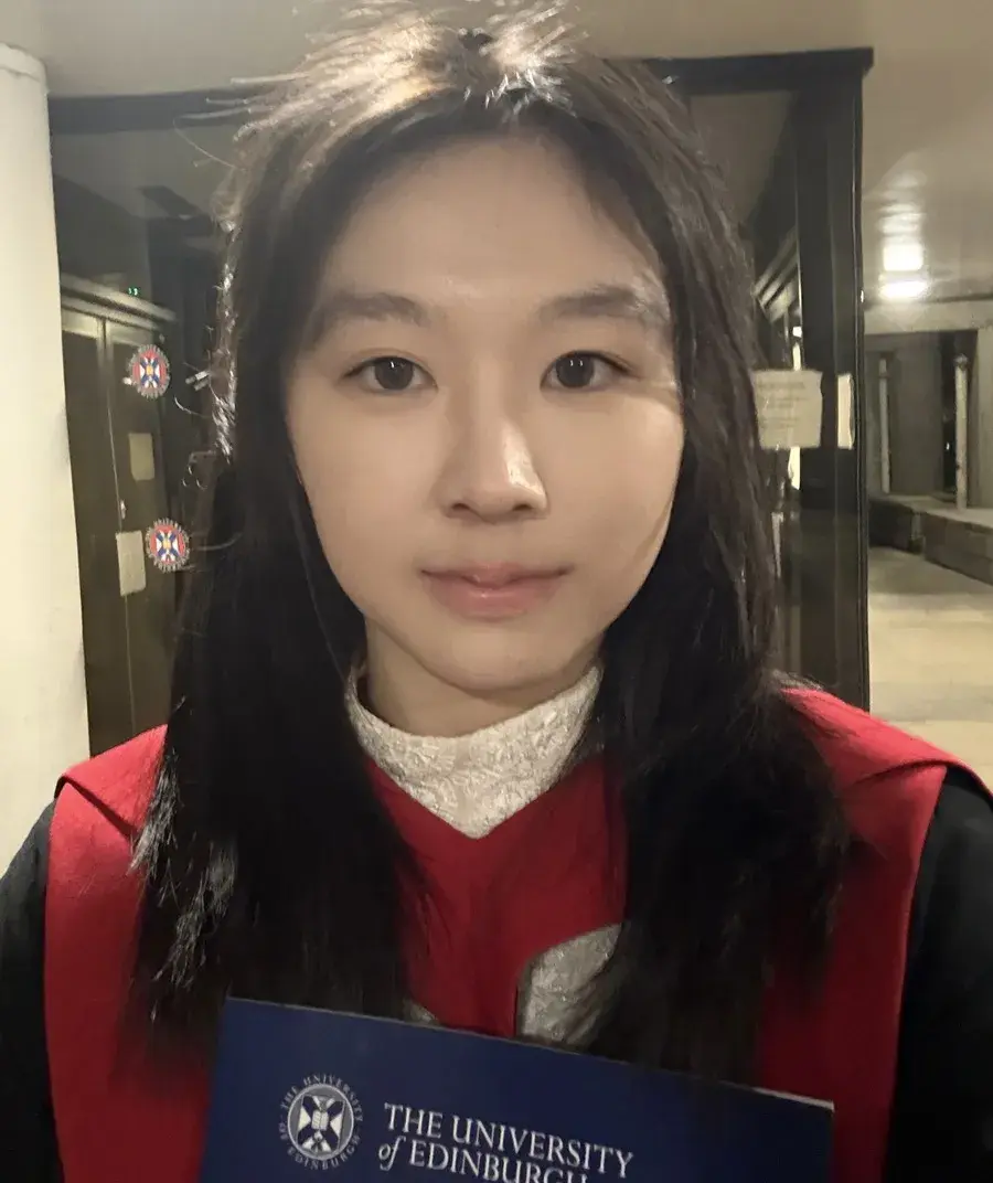 A profile photo of Yashi Gu in her graduation gown