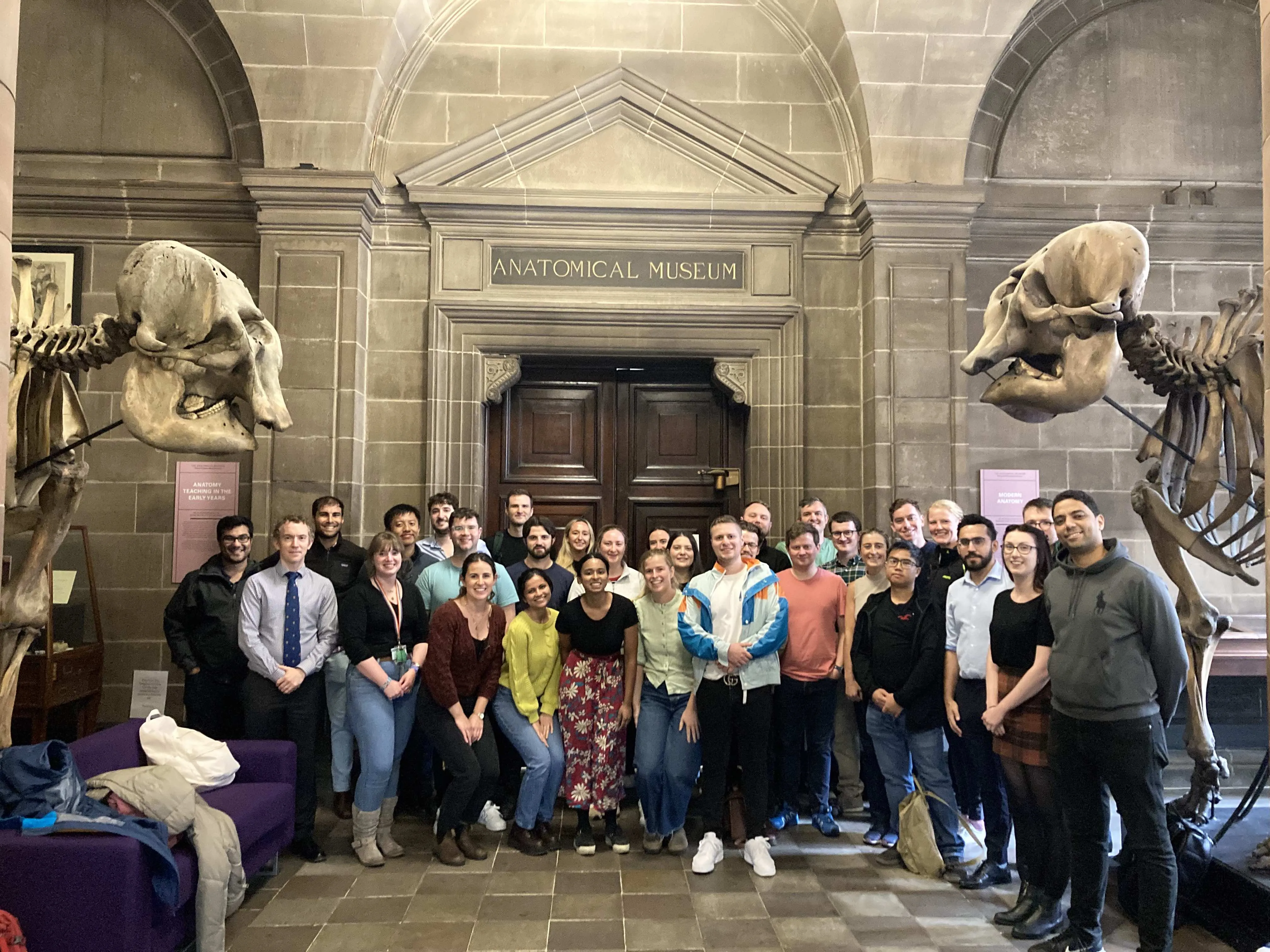 Group photo of NHS Scotland Surgical Trainees by elephant skeletons