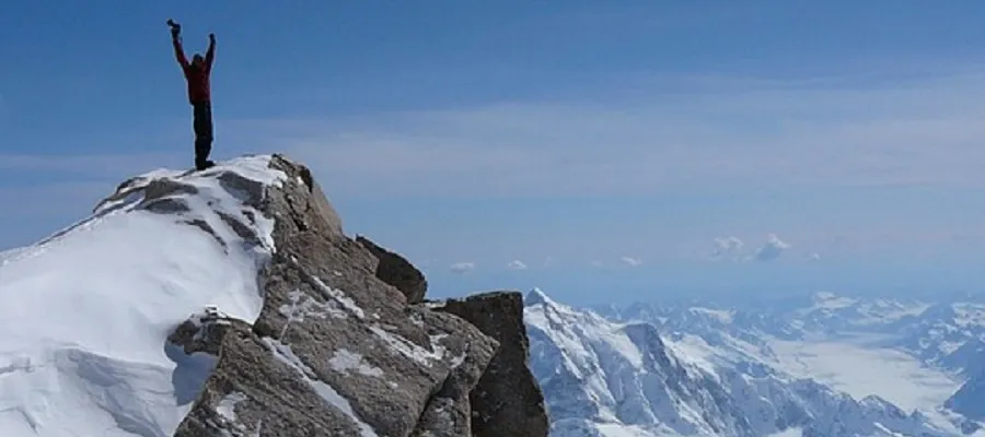 Mountain climber on peak.