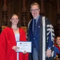 Isla Britton (left) standing with Professor Colm Harmon, Vice-Principal Students
