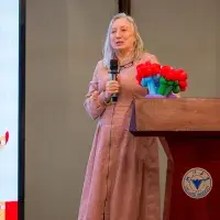 A photo of Prof Sue Welburn speaking at the podium at the ZJE new year event