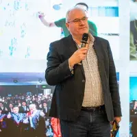 A photo of Prof Mike Shipston standing at the podium and speaking at NY event