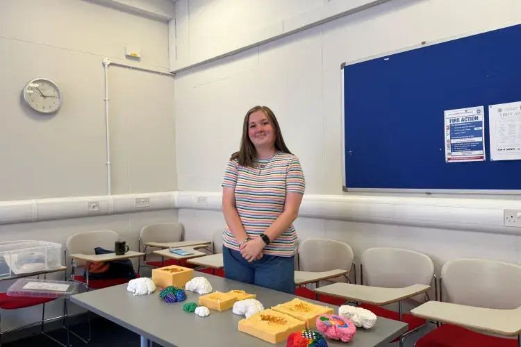Ellie Horne with her two-part silicone mould that could be used to create plaster hemisphere models showing both the internal and external structures of the brain. 