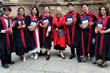 Prof Sue Welburn standing with the 2026 ZJE PG graduates outside the McEwan Hall. 