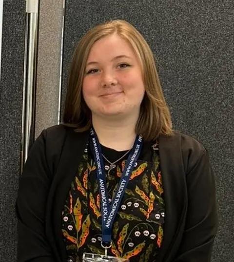 Portrait of Ellie Horne, a student from the Our Minds Scholarship, University of Edinburgh 2025 cohort, smiling confidently.