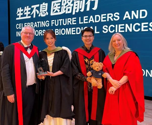 Professors Welburn (r) and Shipston(l) congratulate CHIMO Yumo and Ian Meliala - the student hosts of the 2026 ZJE graduation celebration