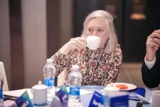 A photo of Prof Sue Welburn drinking tea 