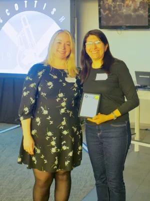 A photo of Dr Martinez-Gonzalez (on the right) receiving her award at the SMOTY Awards 2024
