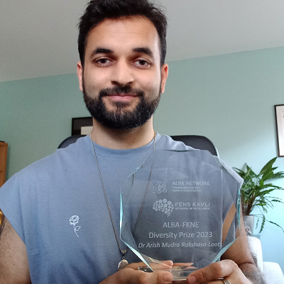 Image of Arish holding his diversity award