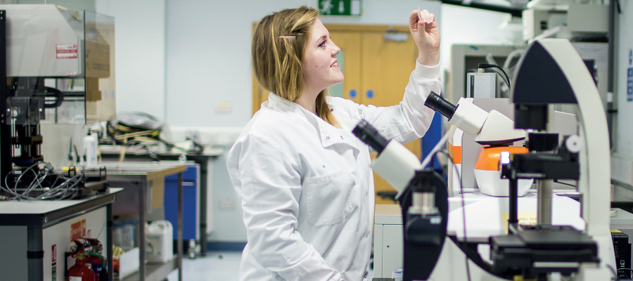 A woman in a lab with microscope