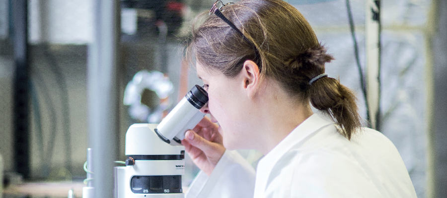 A woman in a lab with microscope