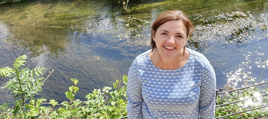 A photo of Harriet Thatcher by a pond