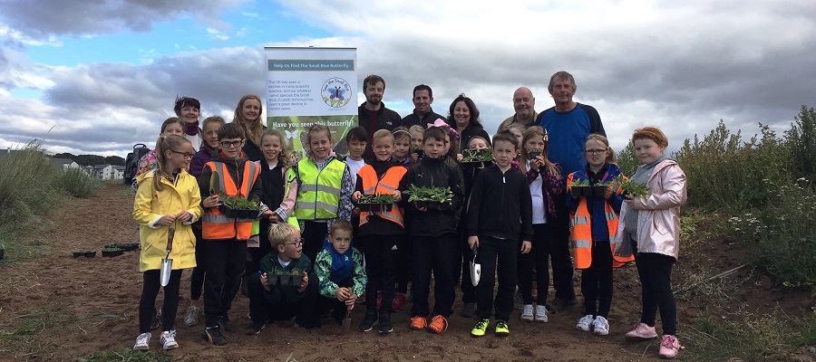 A group photo of Tayside volunteers on a beach